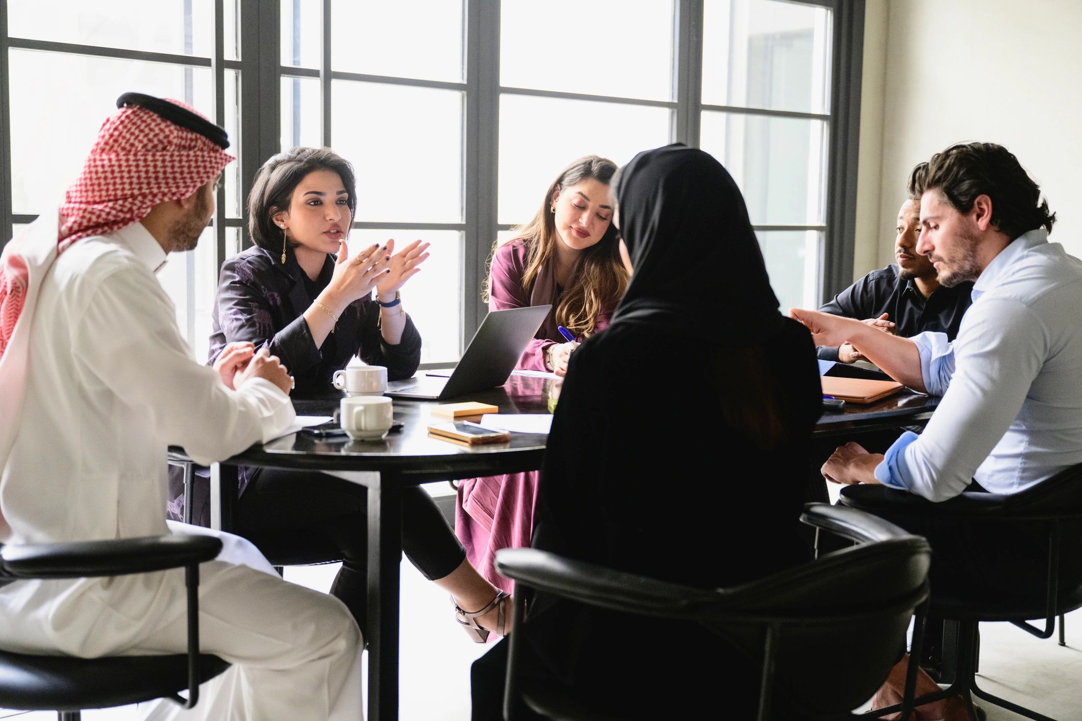 Young Riyadh business team collaborating in meeting room