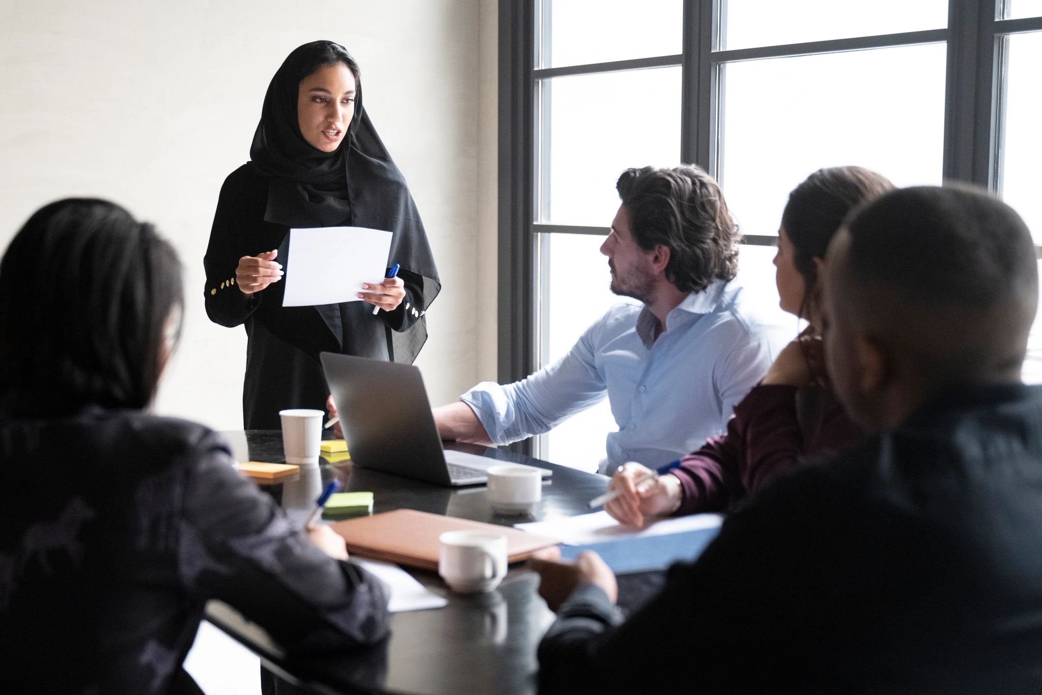Young Saudi businesswoman presenting project ideas to team